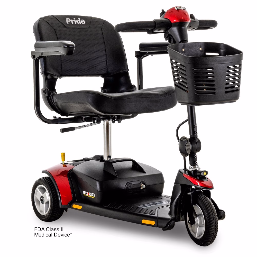 Pride Go Go Elite Traveller 3-wheel travel scooter with red shrouds, front three-quarter view